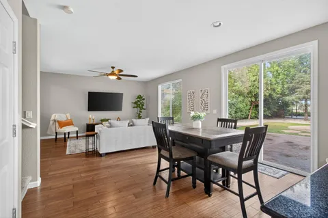 a dining room with furniture and wooden floor