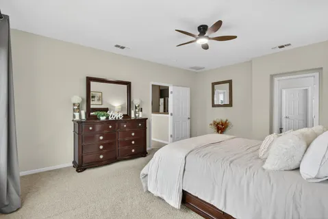 a large bathroom with a double vanity sink a mirror and a bathtub