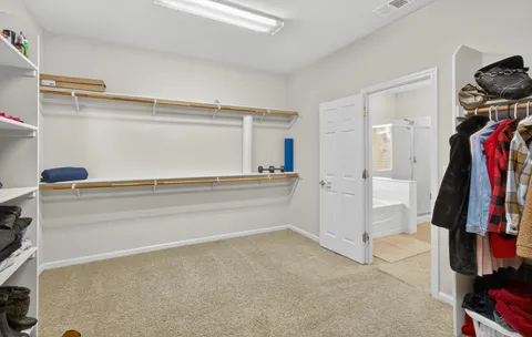 a view of a living room with clothes and shoes