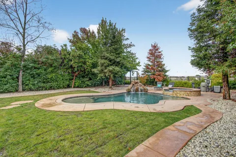 a view of a backyard with swimming pool