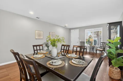 a view of a dining room with furniture and wooden floor