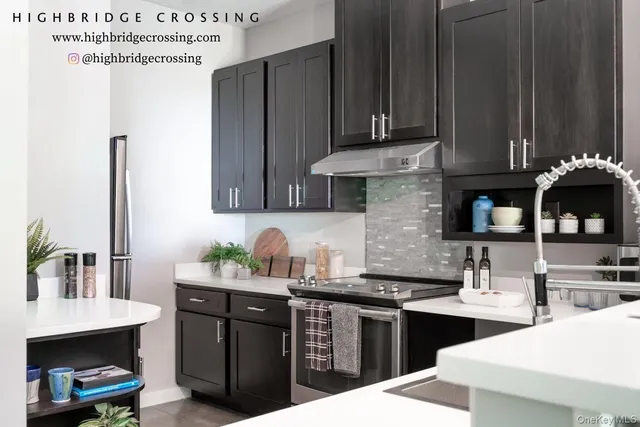 a kitchen with a sink cabinets and wooden floor