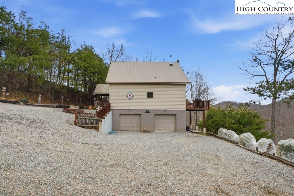 408 Eagle Ridge Road Roan Mountain, TN 37687 - Photo 31 of 45 a front view of a house with a yard and garage