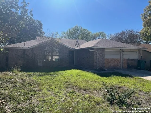 a house with green field in front of it