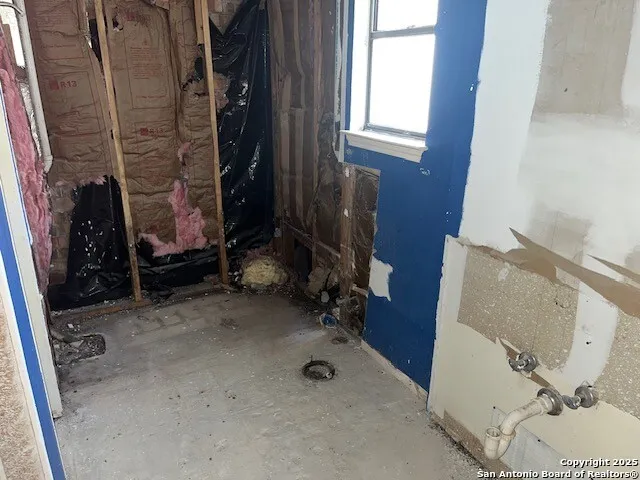 a view of a patio with table and chairs and potted plants