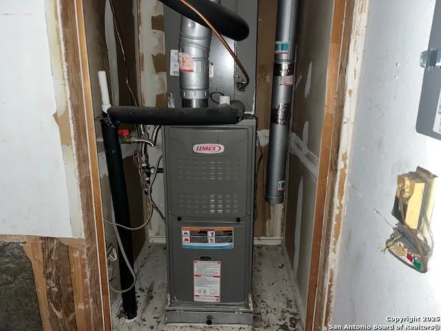 an empty room with fireplace and windows