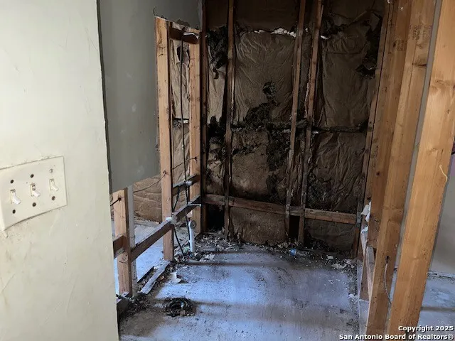 a view of a bathroom with tub and mirrors