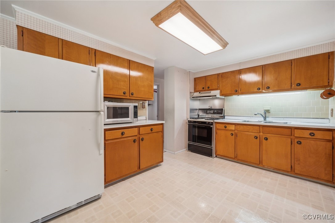 1409 Seward Drive Hampton, VA 23663 - Photo 11 of 35 a kitchen with granite countertop stainless steel appliances and refrigerator