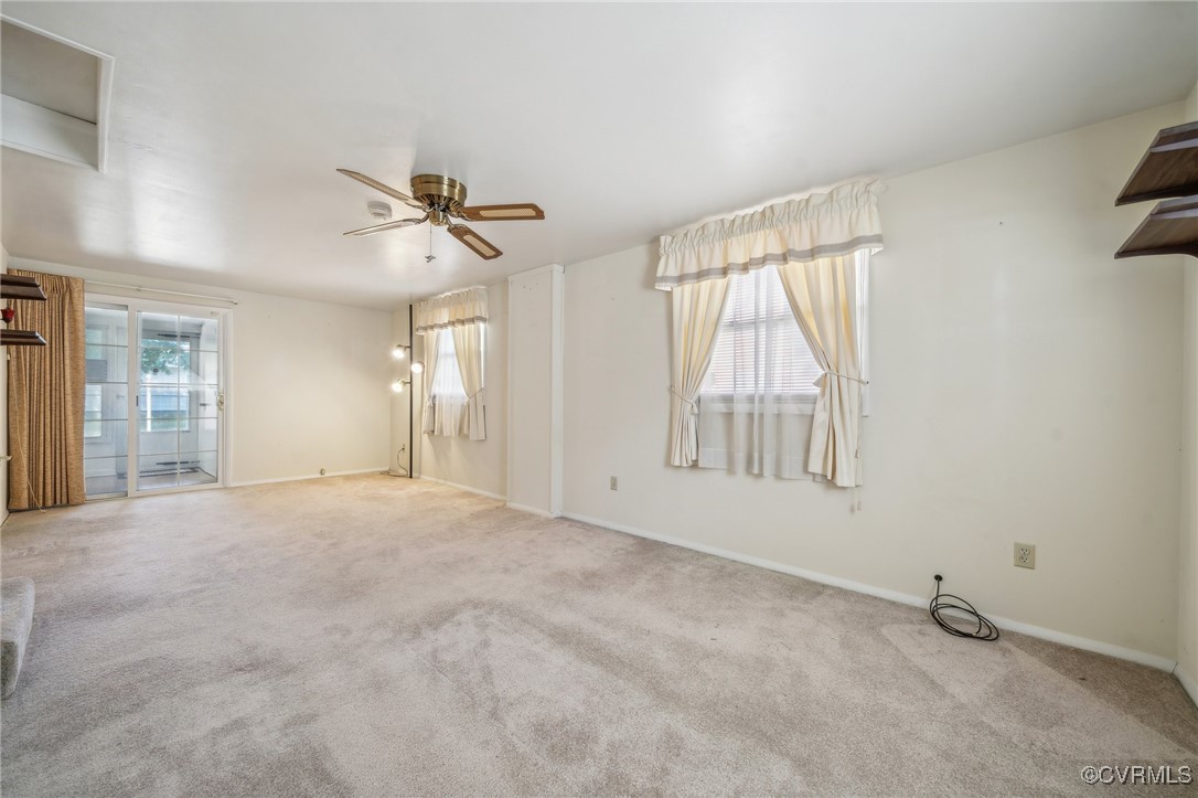 1409 Seward Drive Hampton, VA 23663 - Photo 16 of 35 an empty room with chandelier fan and windows