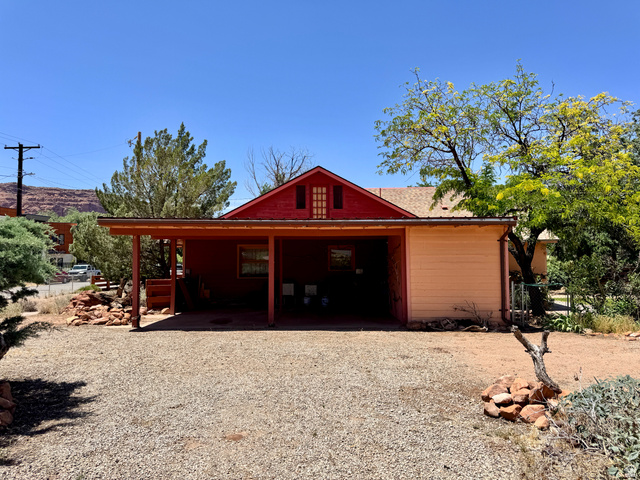 178 Walnut Lane Moab, UT 84532 - Photo 6 of 25 Red-sided residence featuring a covered carport, pitched roof, and a visible attic vent