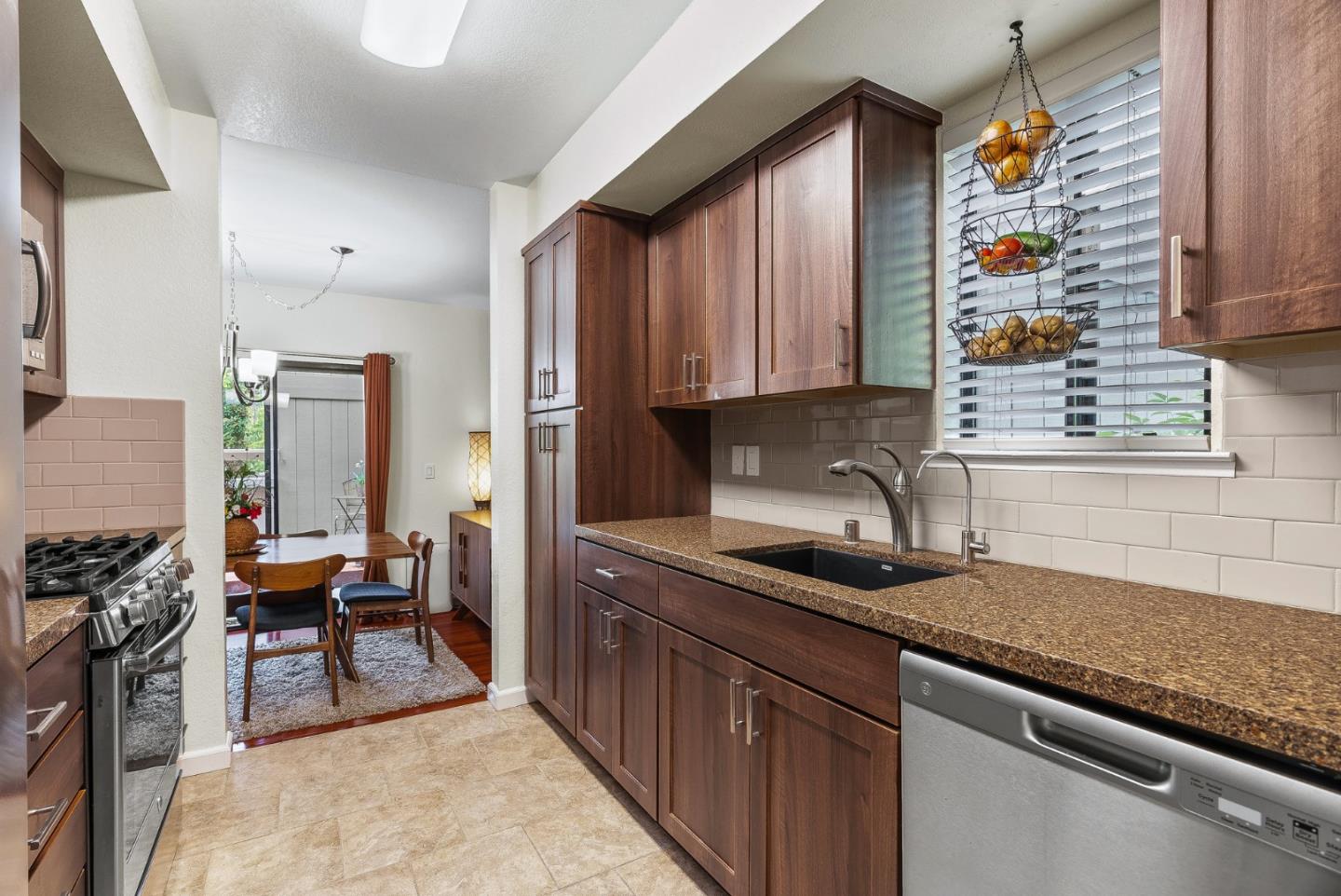a kitchen with a sink stove and cabinets