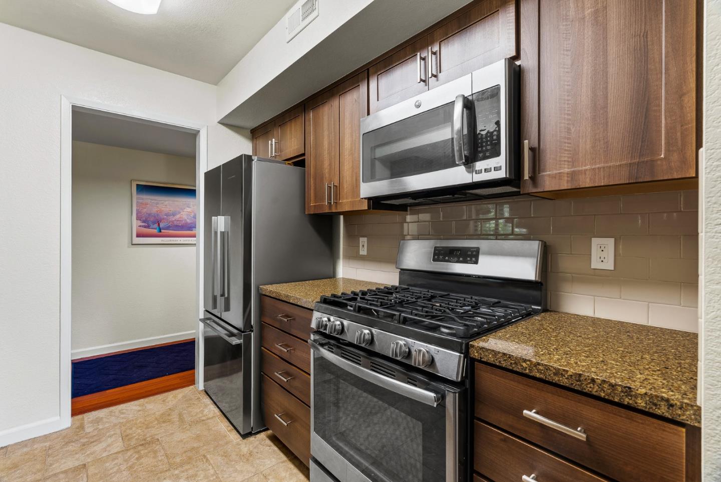 111 Bean Creek Road, Unit 115 Scotts Valley, CA 95066 - Photo 11 of 24 a kitchen with stainless steel appliances granite countertop a stove and a microwave