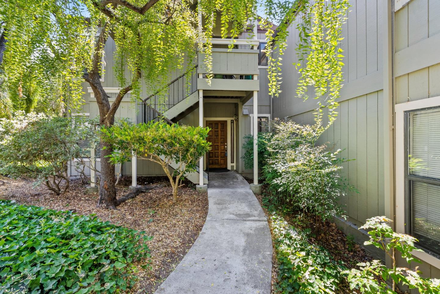 111 Bean Creek Road, Unit 115 Scotts Valley, CA 95066 - Photo 2 of 24 a backyard with plants and large tree