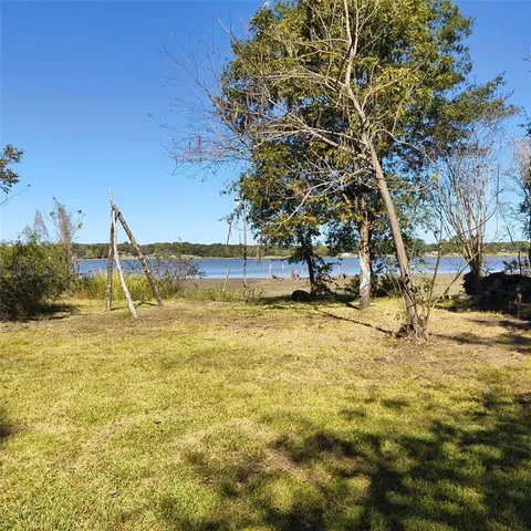 a view of a yard with swimming pool