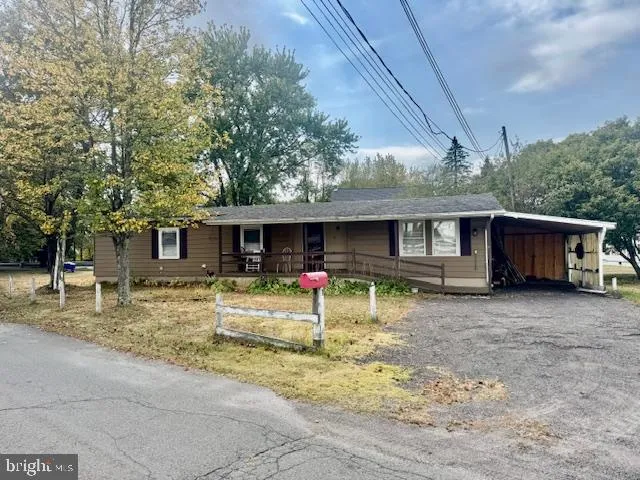 a view of a house with a patio and a yard