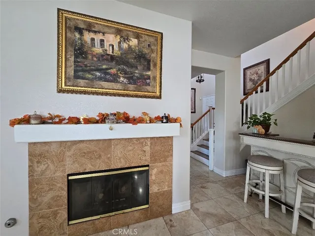 a living room with a fireplace and a potted plant