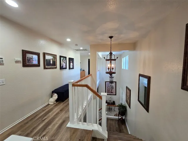 a view of a livingroom with wooden floor and stairs