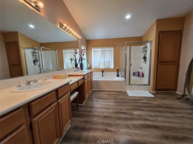 a large bathroom with double vanity sinks a large mirror and a shower