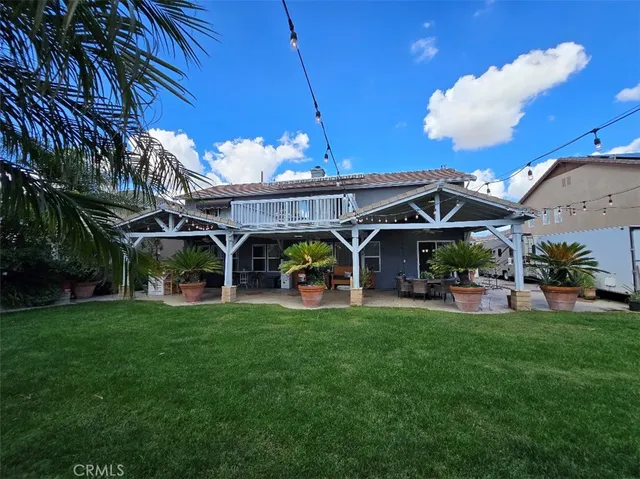 a view of a house with backyard and patio