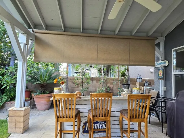 a view of an outdoor dining space with furniture and garden view