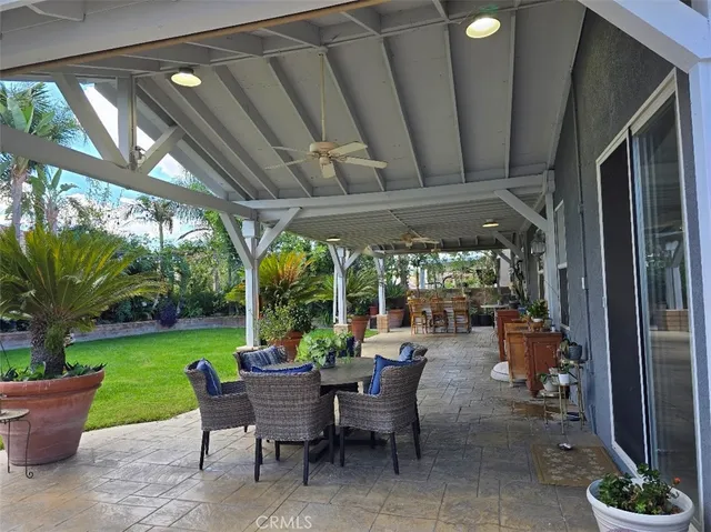a view of a porch with chairs and backyard