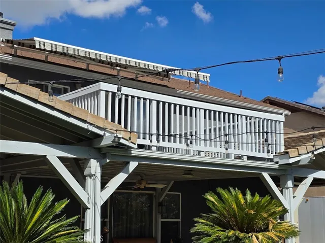 a view of a balcony with a floor to ceiling window and wooden floor