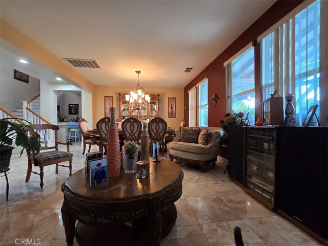 a living room with lots of furniture and a large window