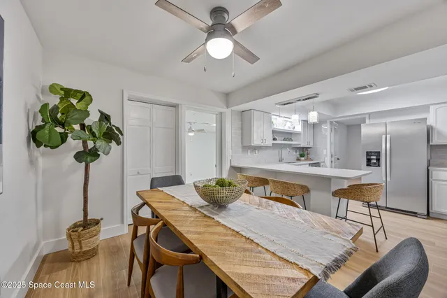 a view of a dining room with furniture and a chandelier