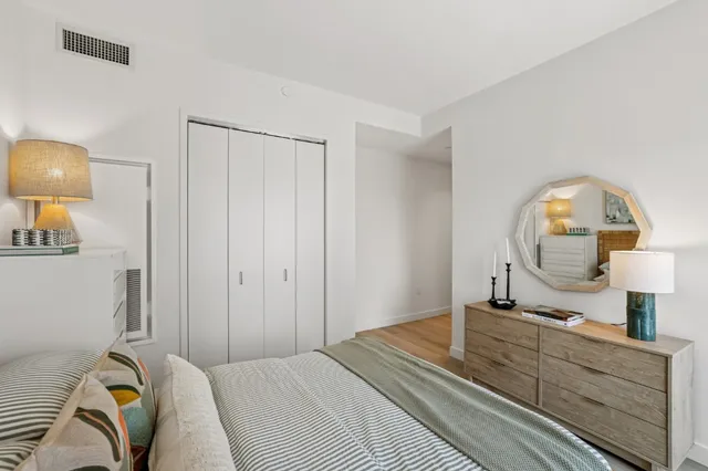 a bedroom with a bed and a dresser