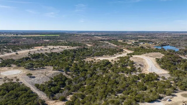 an aerial view of a houses with a lake