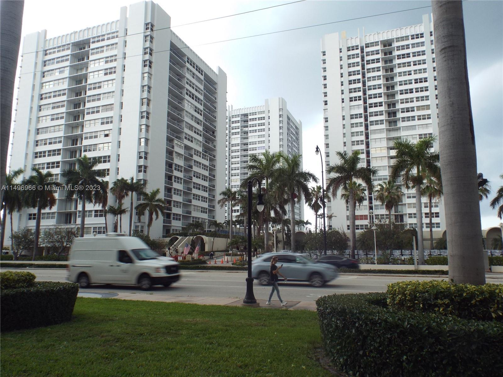 a view of a city with tall buildings and a yard
