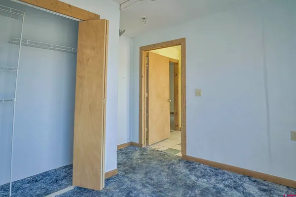 a bathroom with a granite countertop sink a toilet and a mirror