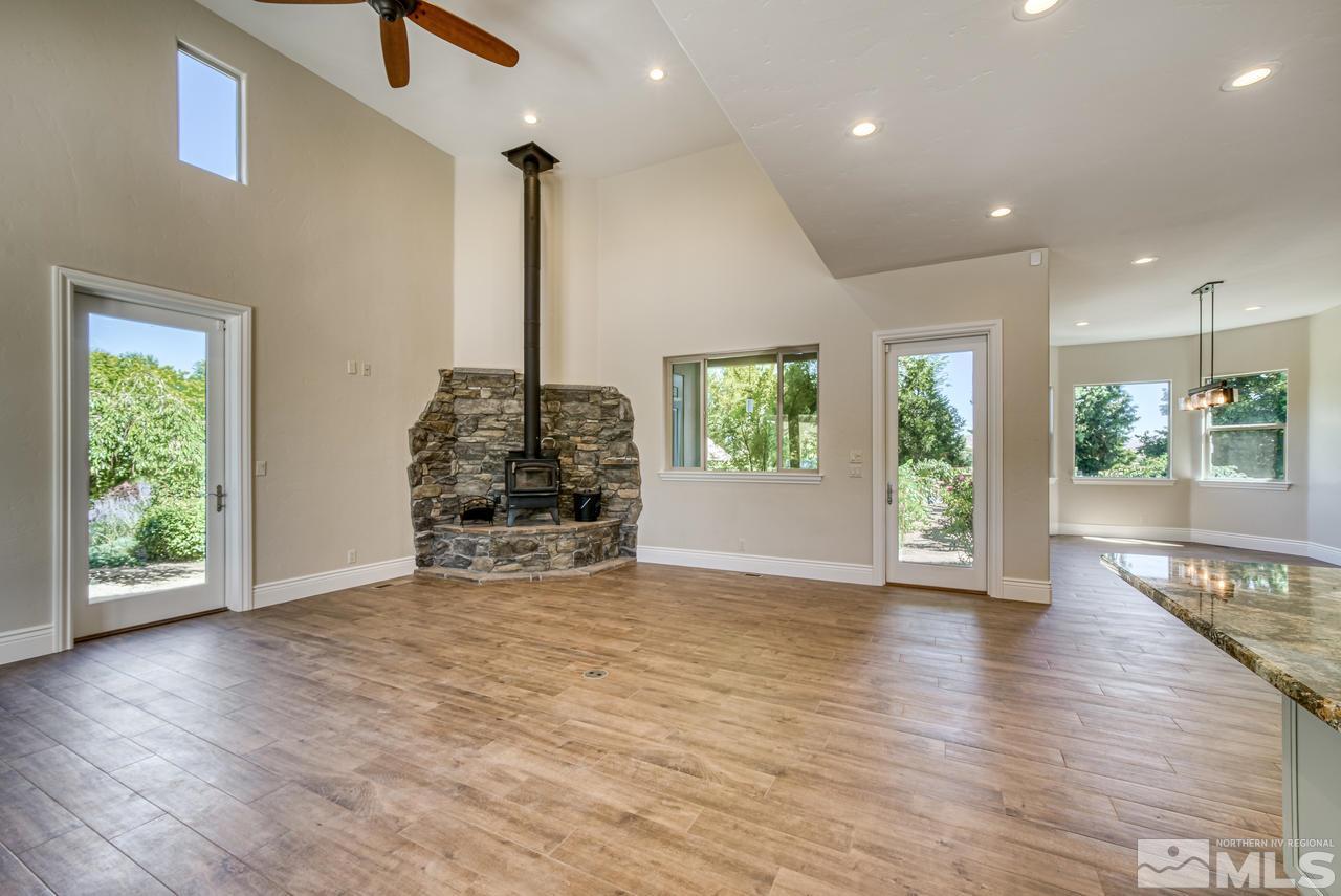 10049 Casazza Ranch Lane Reno, NV 89511 - Photo 8 of 40 a view of an empty room with wooden floor and a window