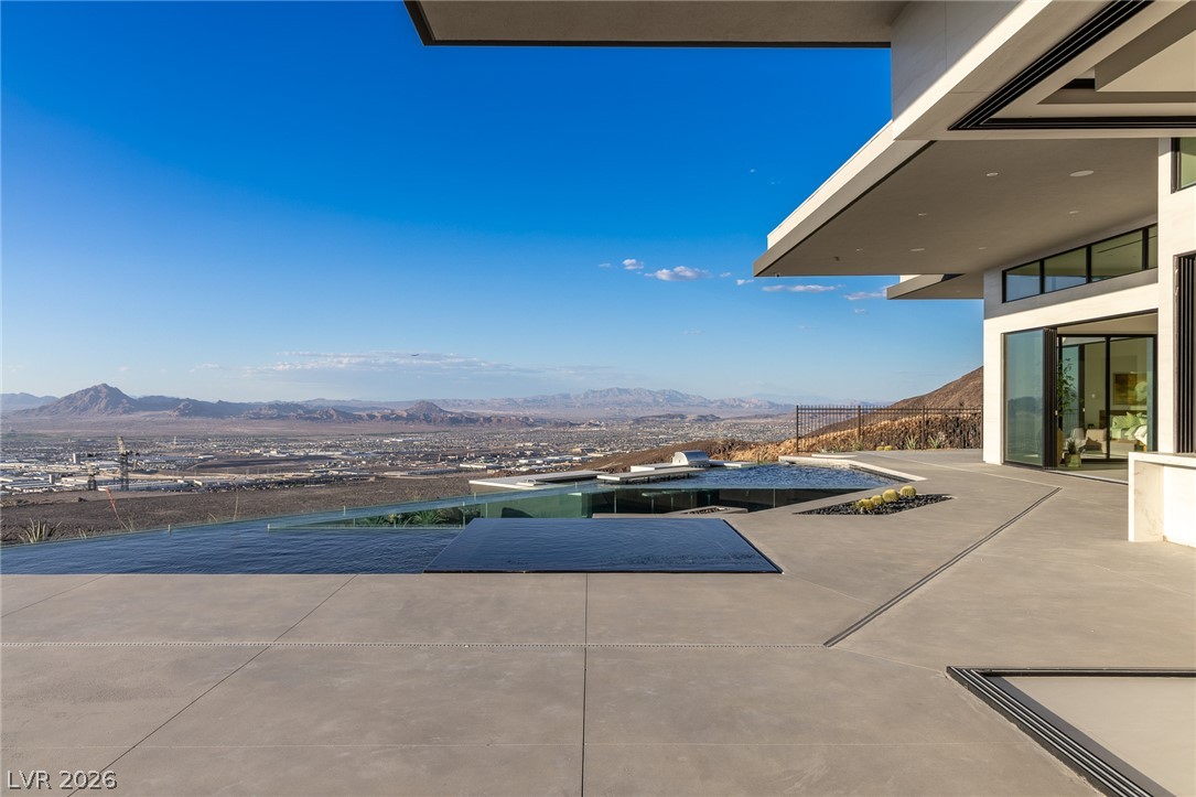 563 Grand Rim Drive Henderson, NV 89012 - Photo 65 of 70 Infinity pool and grand patio deliver breathtaking views of the distant city and mountains.