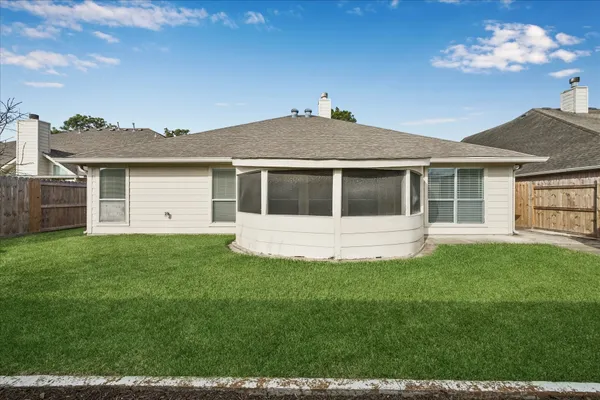 a view of a house with a backyard