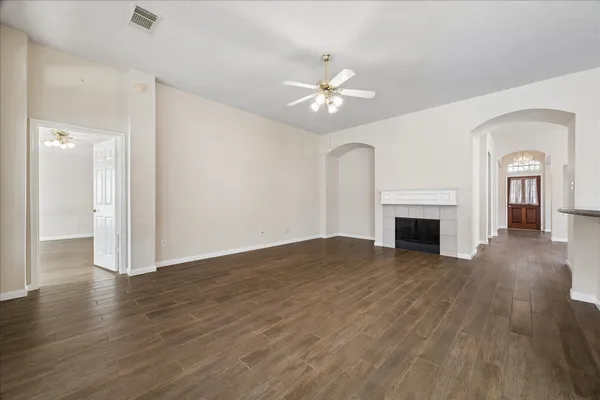a view of empty room with wooden floor and fireplace