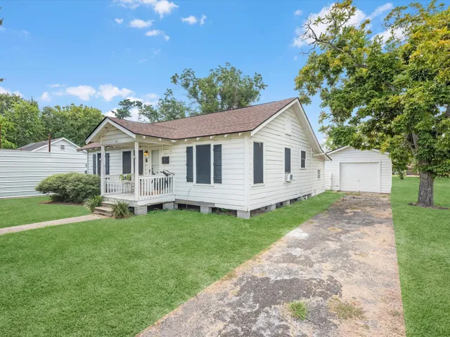 a view of a house with a yard and sitting area