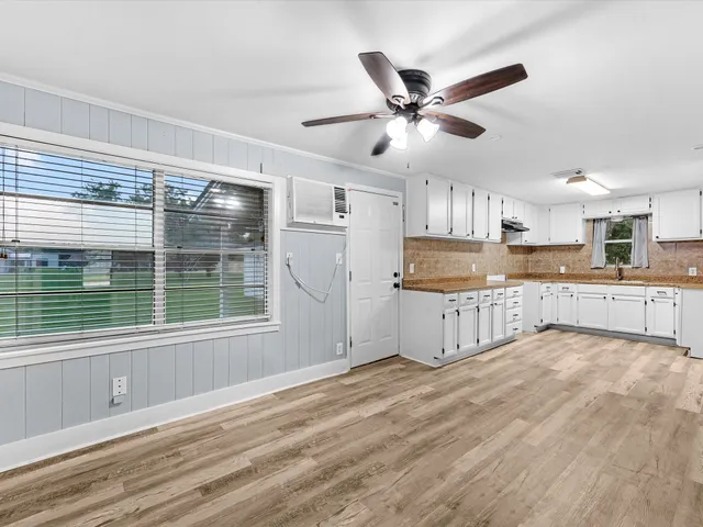 a kitchen with granite countertop a stove a sink and a refrigerator