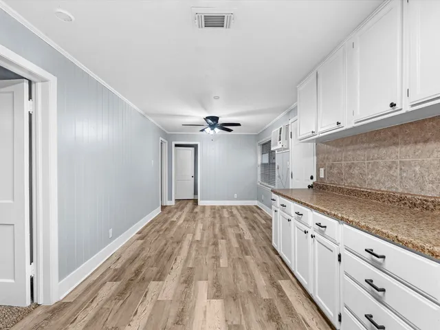 a kitchen with granite countertop a sink window and stainless steel appliances