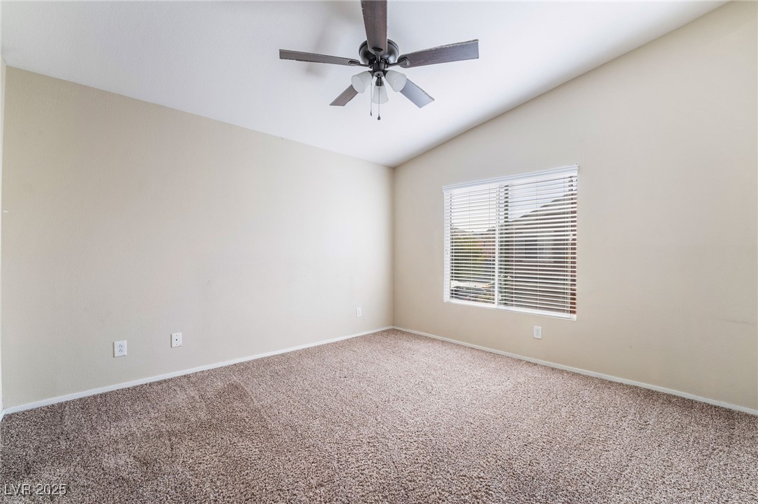 1570 Rusty Ridge Lane Henderson, NV 89002 - Photo 21 of 35 Carpeted empty room with baseboards, a ceiling fan, and lofted ceiling