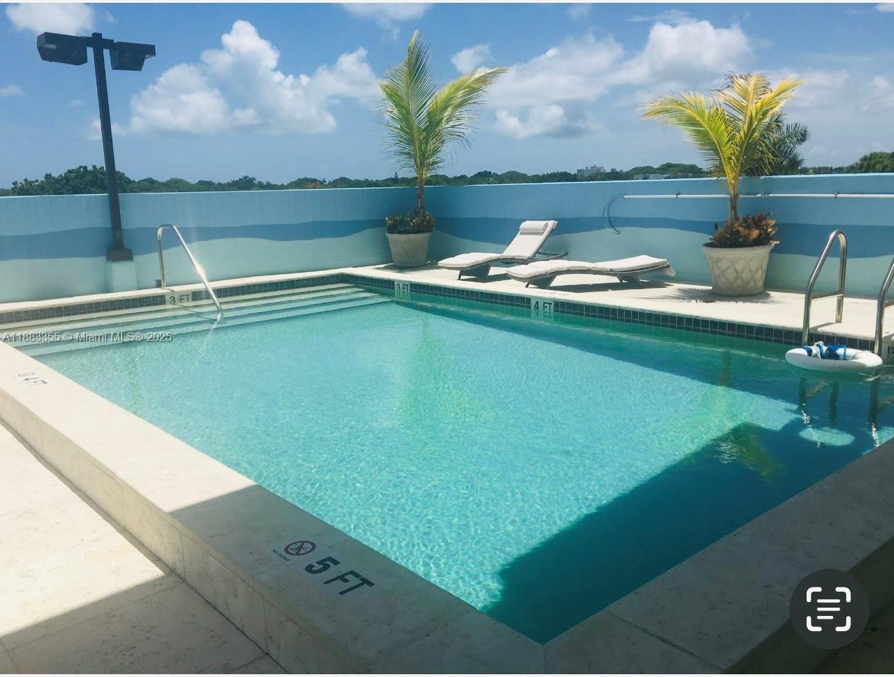 a view of a lake with couches and wooden floor