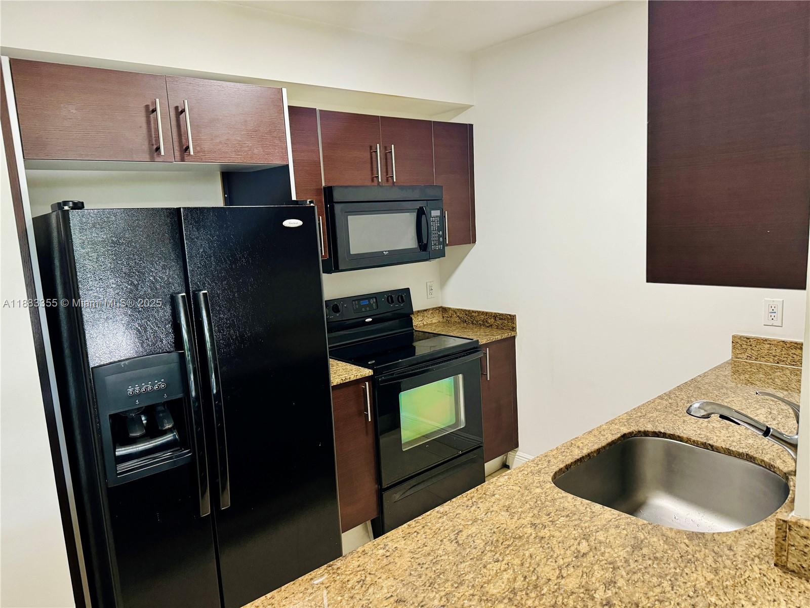 2701 Southwest 3rd Avenue, Unit 201 Miami, FL 33129 - Photo 12 of 16 a kitchen with a sink and a refrigerator