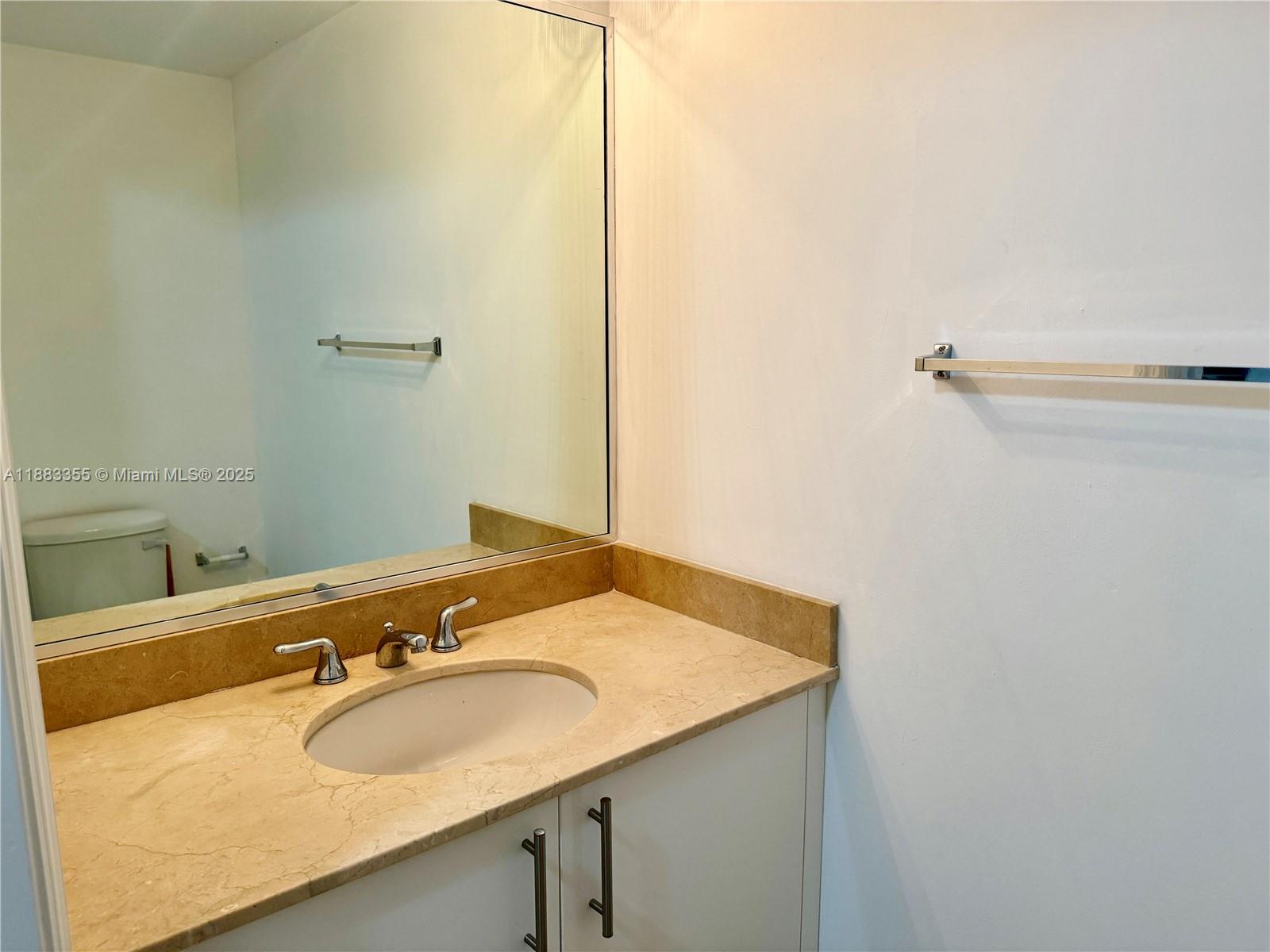 2701 Southwest 3rd Avenue, Unit 201 Miami, FL 33129 - Photo 13 of 16 a bathroom with a sink and a mirror