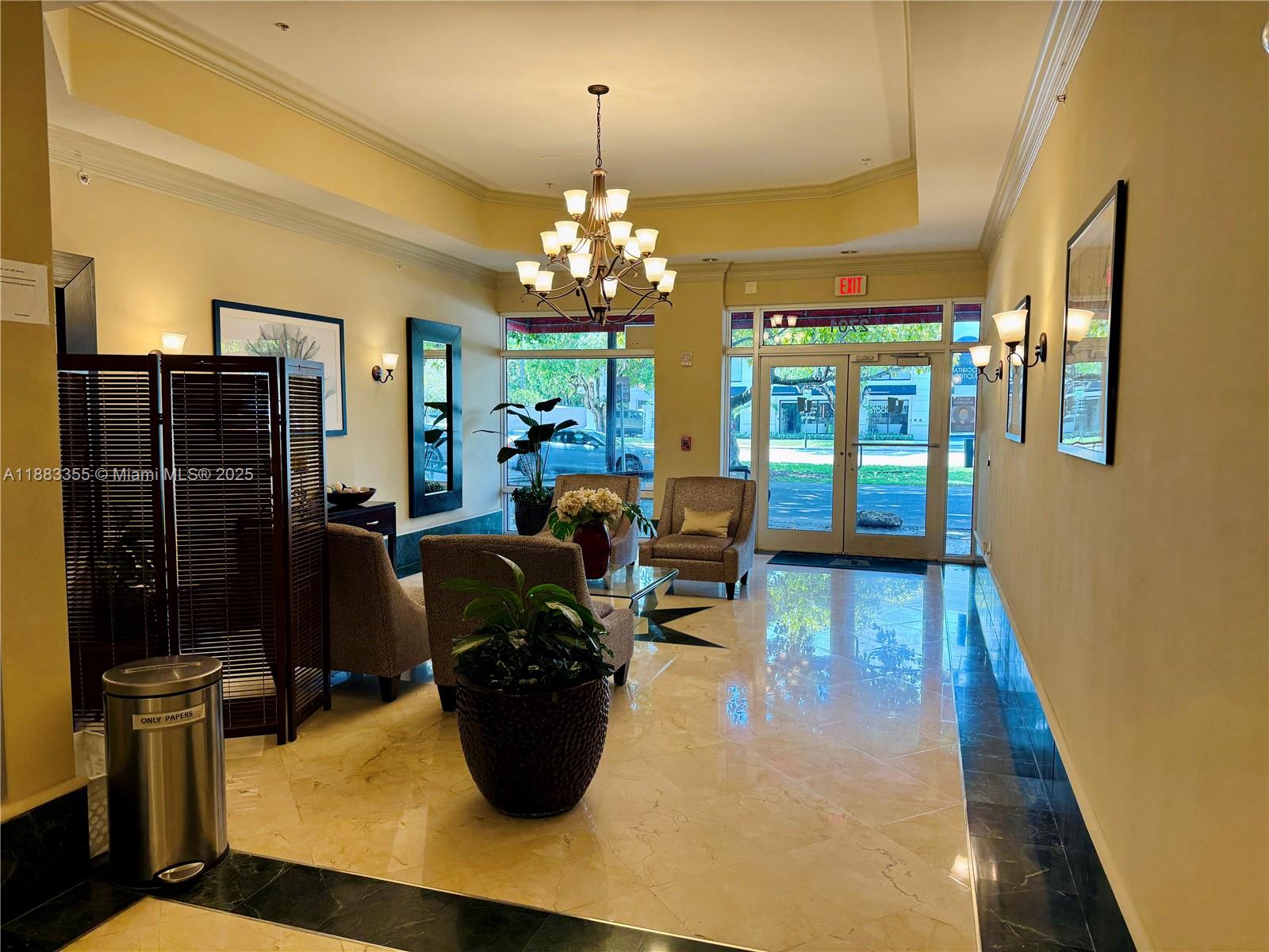 2701 Southwest 3rd Avenue, Unit 201 Miami, FL 33129 - Photo 2 of 16 a view of a dining room with furniture a chandelier and wooden floor
