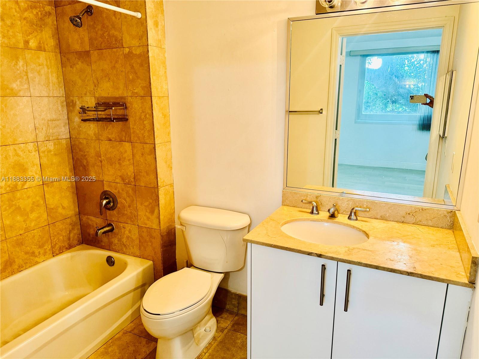 2701 Southwest 3rd Avenue, Unit 201 Miami, FL 33129 - Photo 7 of 16 a bathroom with a granite countertop toilet a sink and a bathtub