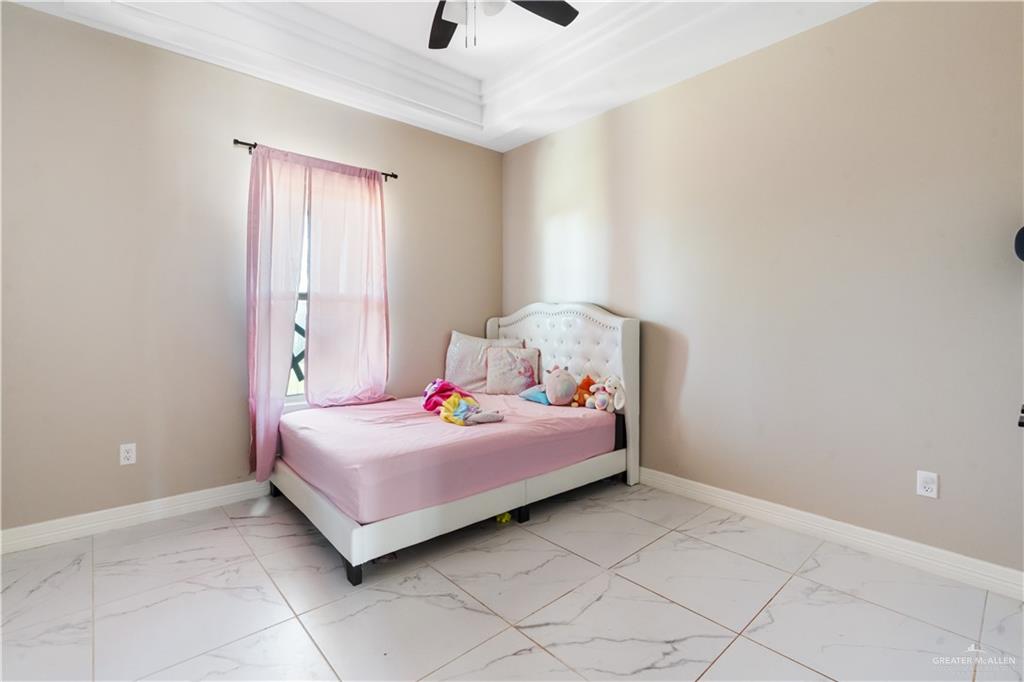822 Whitewing Street Alamo, TX 78516 - Photo 8 of 11 a bedroom with a bed and a window