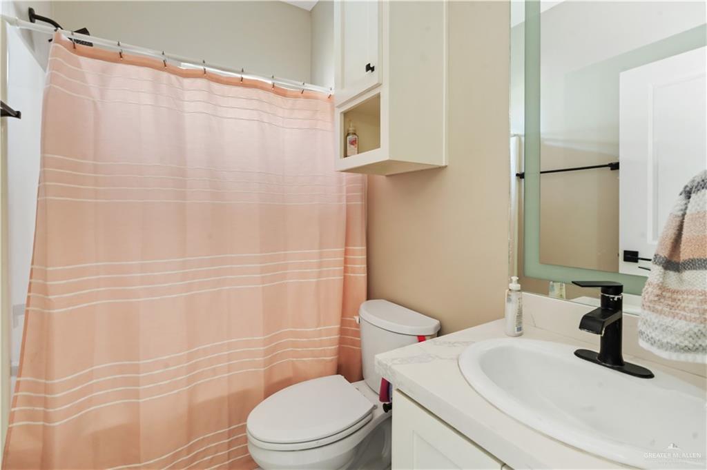 822 Whitewing Street Alamo, TX 78516 - Photo 9 of 11 a bathroom with a sink toilet and shower