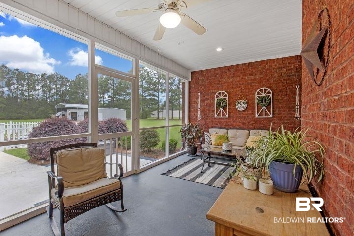24541 Baldwin Beach Expressway Robertsdale, AL 36567 - Photo 36 of 51 Sunroom with plenty of natural light, an outdoor hangout area, and ceiling fan