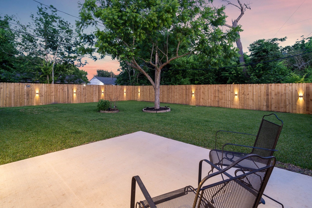 3138 Sunbeam Street Houston, TX 77051 - Photo 47 of 50 Relax beneath the stars in a serene backyard setting featuring glowing fence lighting and a peaceful private atmosphere.