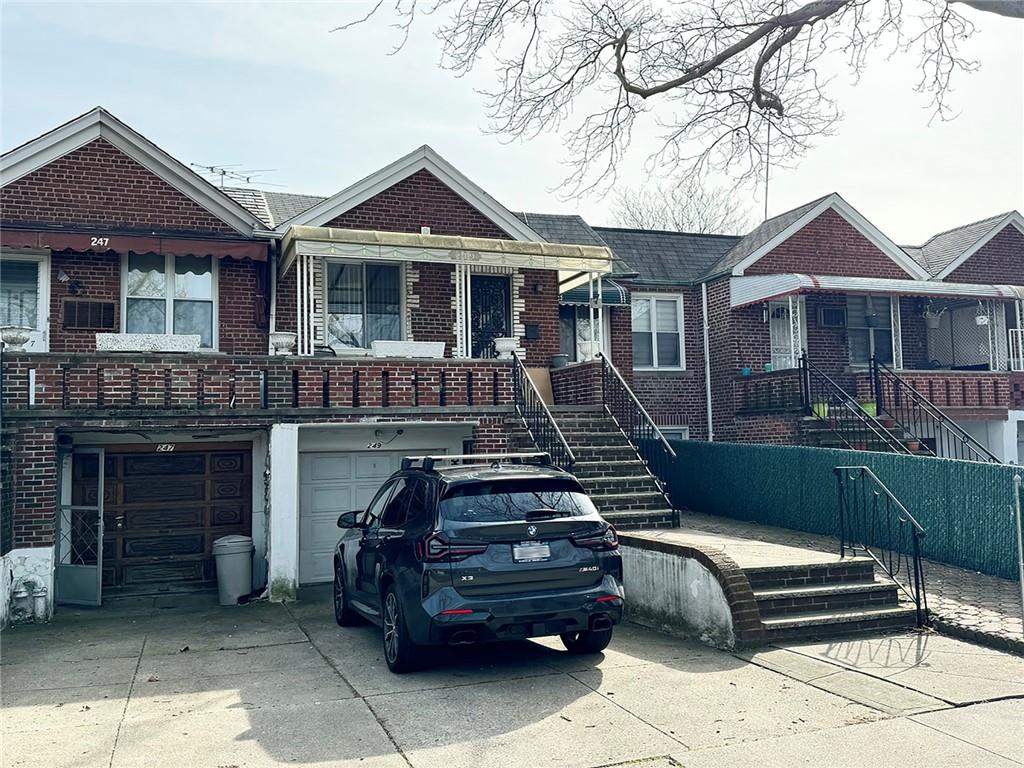 249 Bay 22nd Street Brooklyn, NY 11214 - Photo 1 of 12 a front view of a house with a garden